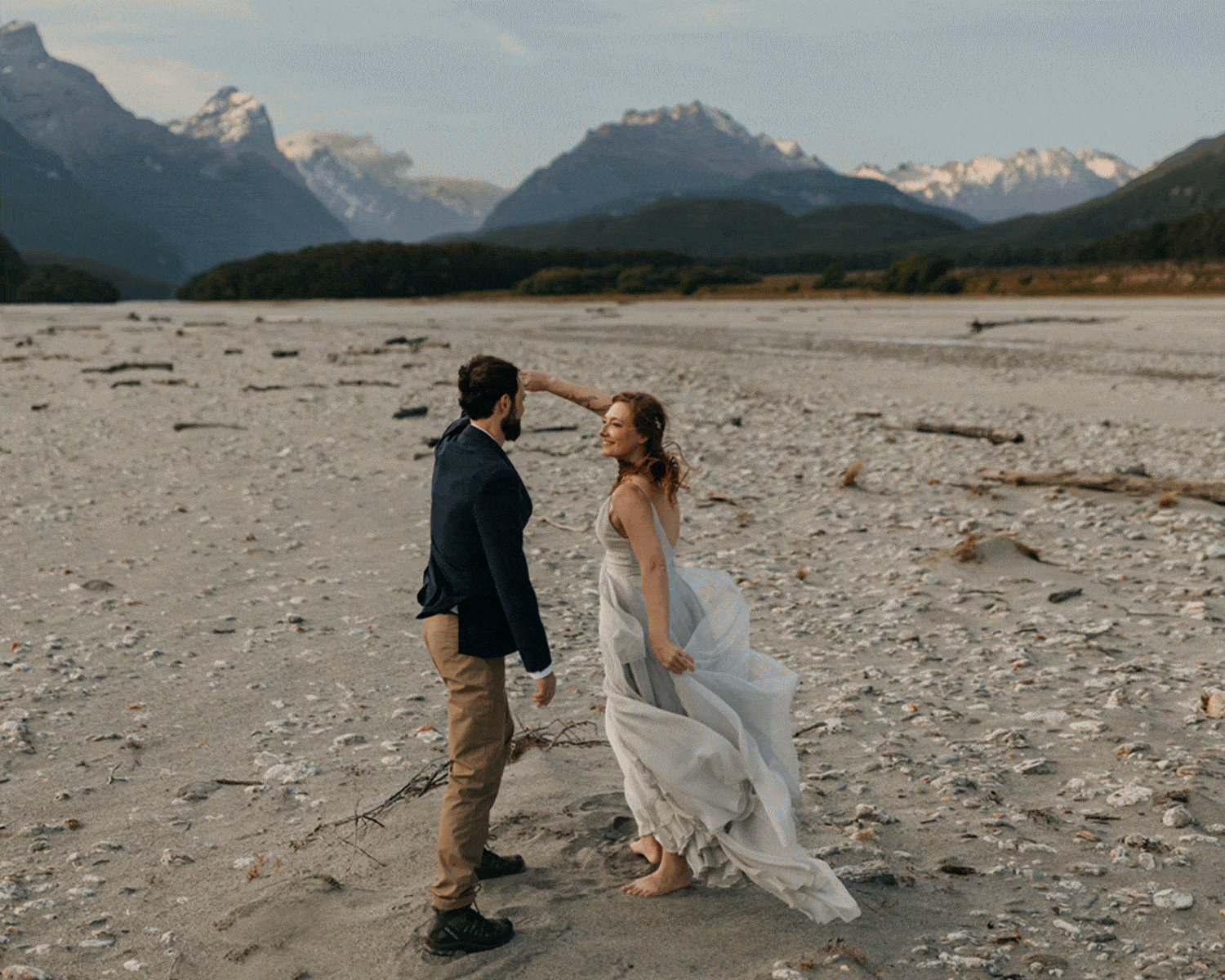 A bride spins and then her groom kisses her.