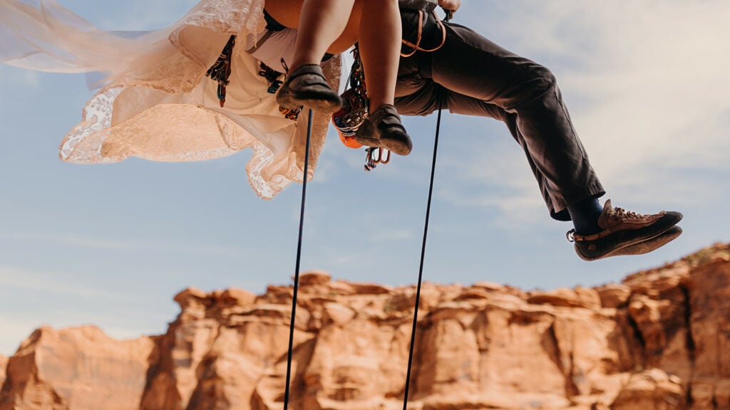 A detail photo of the couples shoes as they rappel down.