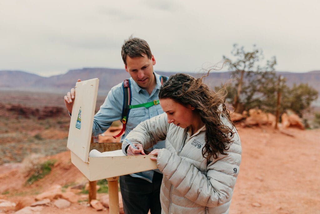 The couple signs the trail registry before starting their hike.