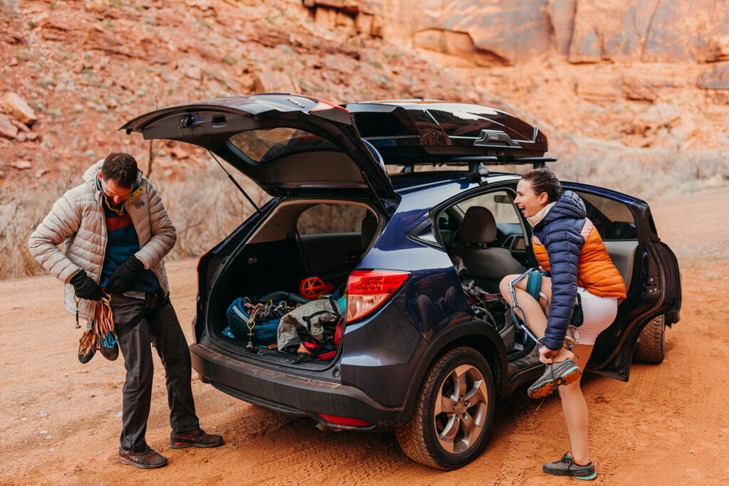 The couple gears up at their car for the climb.