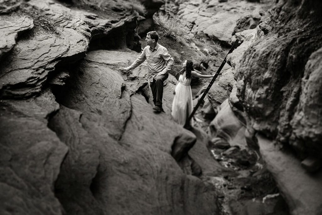 The couple looks towards the trail after coming down the ladder.