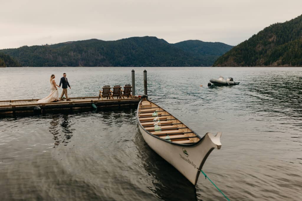 A couple walks along the dock at Lake Crescent.