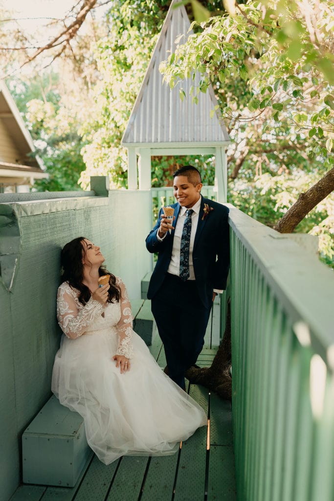 A couple shares ice cream cones together.