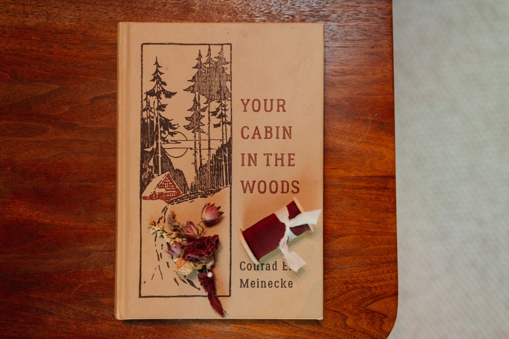 A detail photo of the book in the cabin with the flowers and ribbon for the bouquet. 