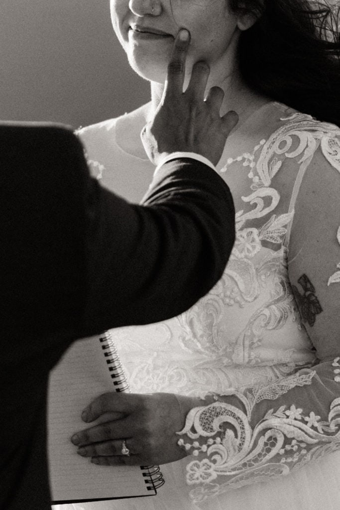 A sweet moment during the ceremony where the bride wipes a tear away.