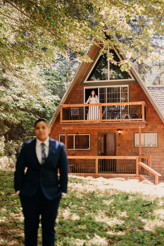A moment before the two brides see each other, Alex looks out of the balcony towards Megan. 