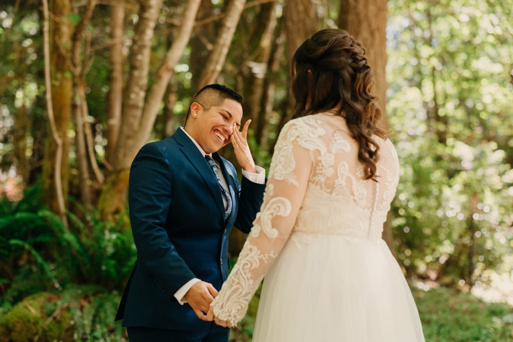 An emotional first look where the bride smiles and cries. 