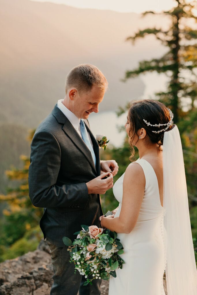 A groom gives a ring to his bride.