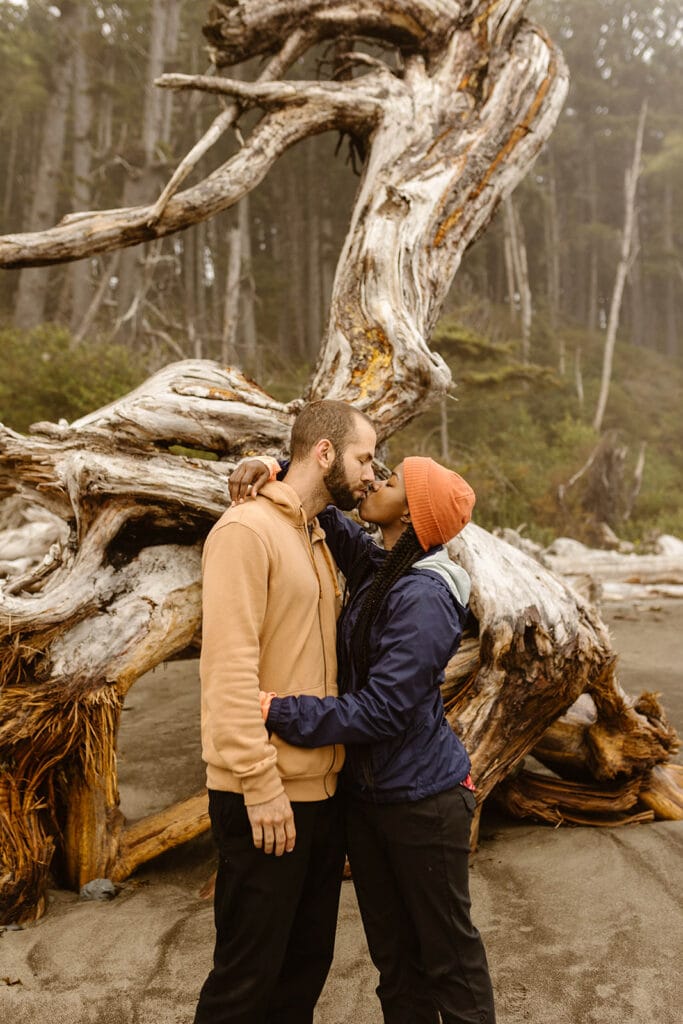 A couple kisses on the coast.