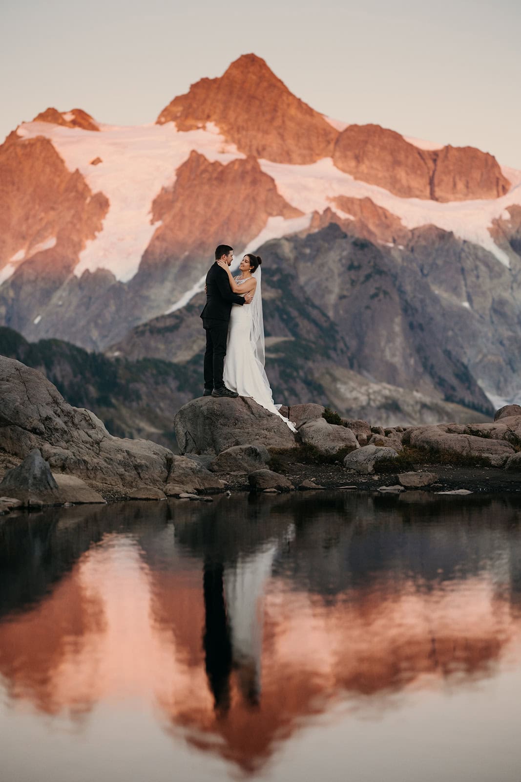 A photo of a couple at sunset at artist point facing mt shuksan