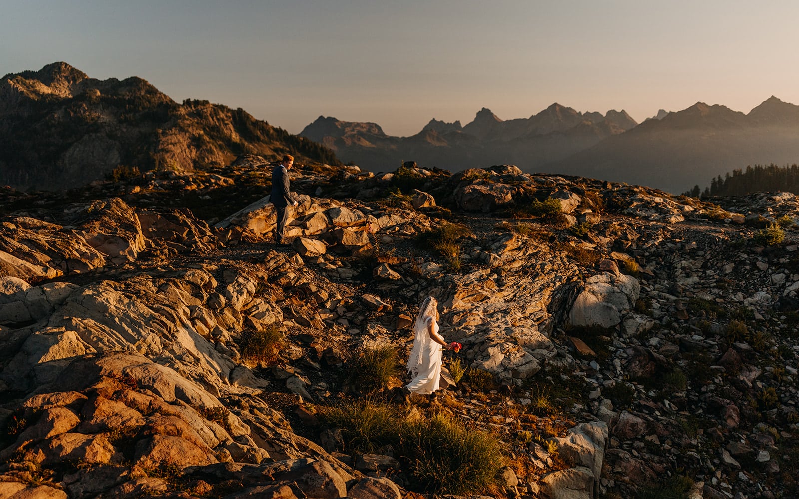 The couple hikes down the trail.