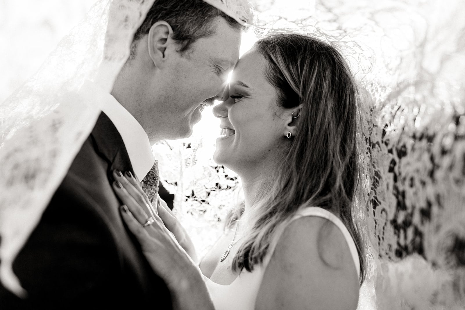 An intimate portrait of the couple under the lace veil. 