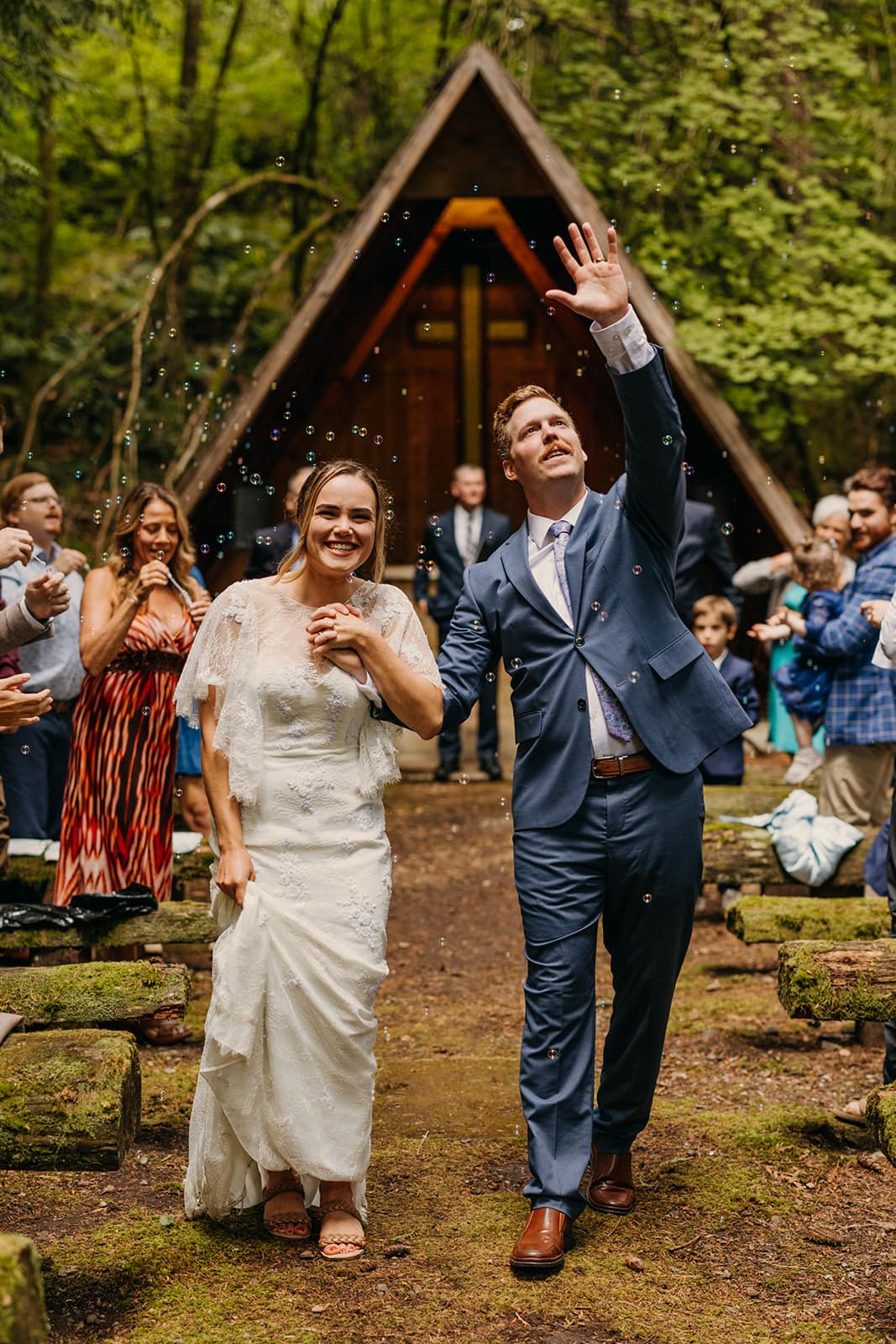 The couple walks back down the aisle after getting married.