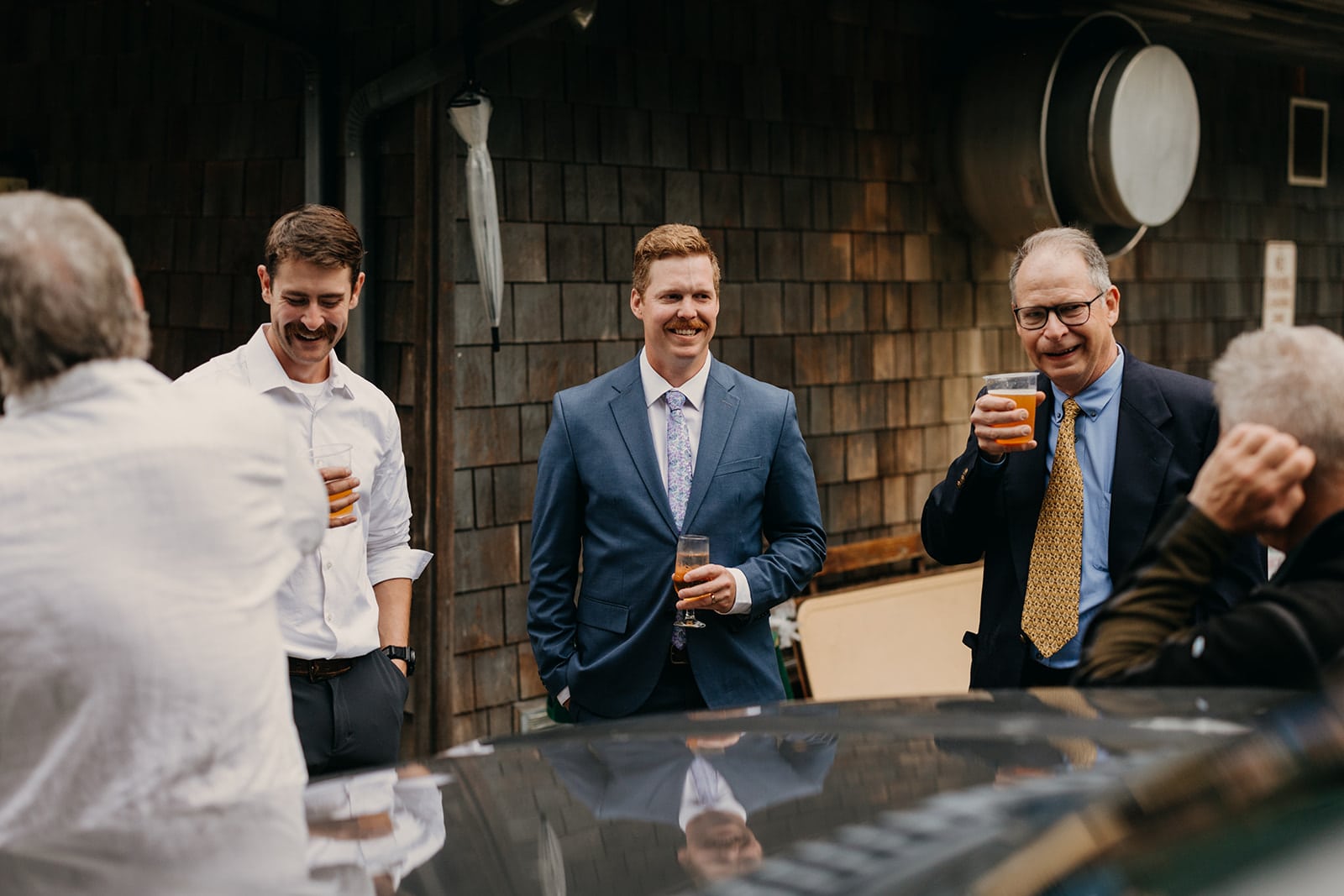 The groom chats with guests.