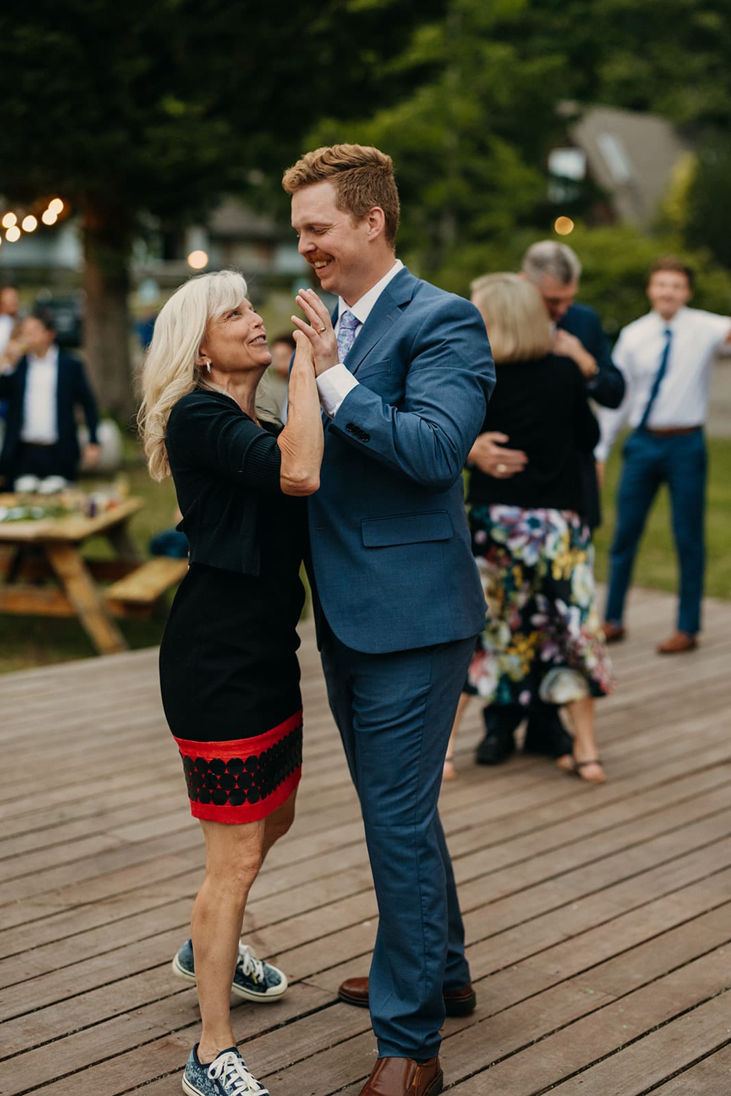 The groom dances with his mom.