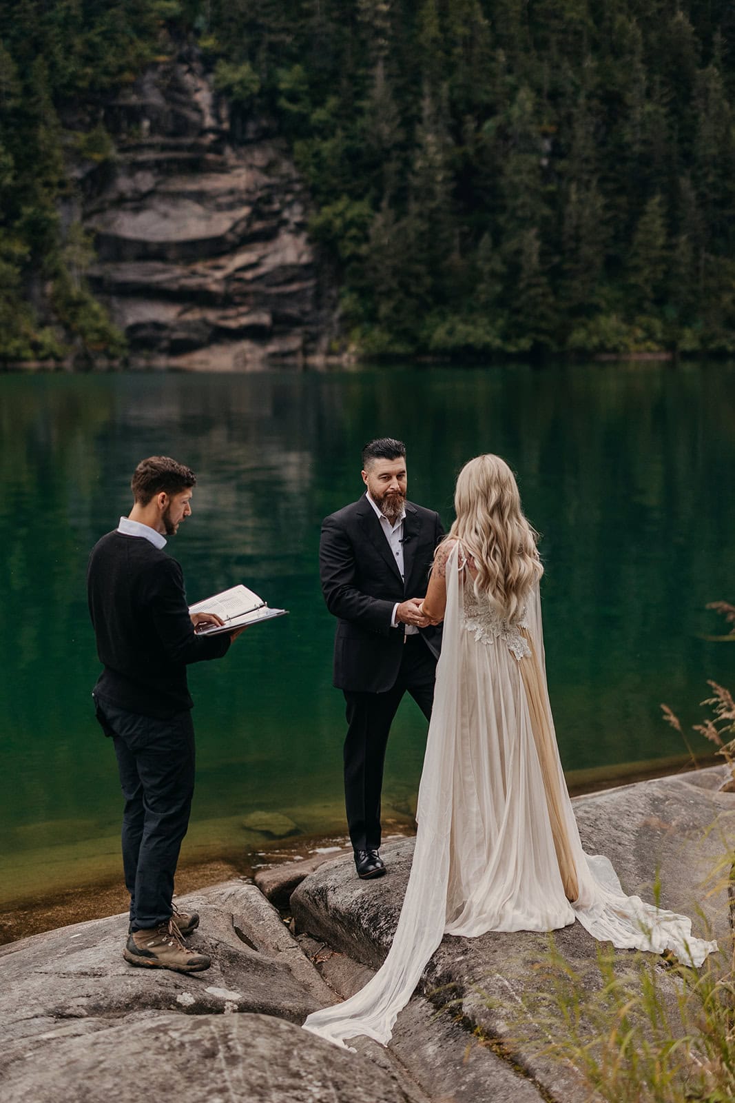 A groom looks at his bride during their elopement ceremony.
