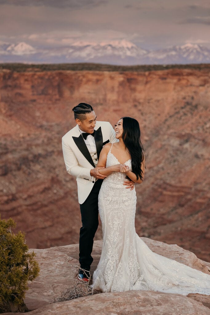 The couple looks at each laughing.