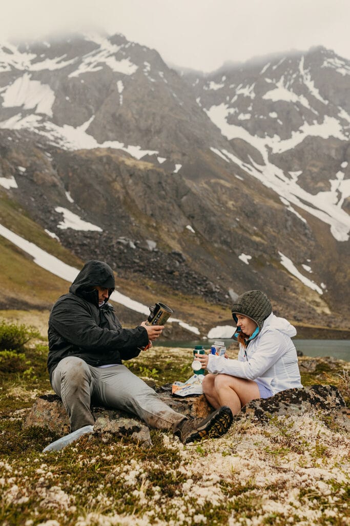 A couple makes freeze dried meals at camp.