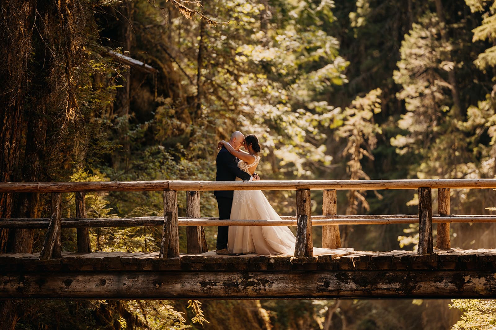 A couple share a moment on the bridge together.