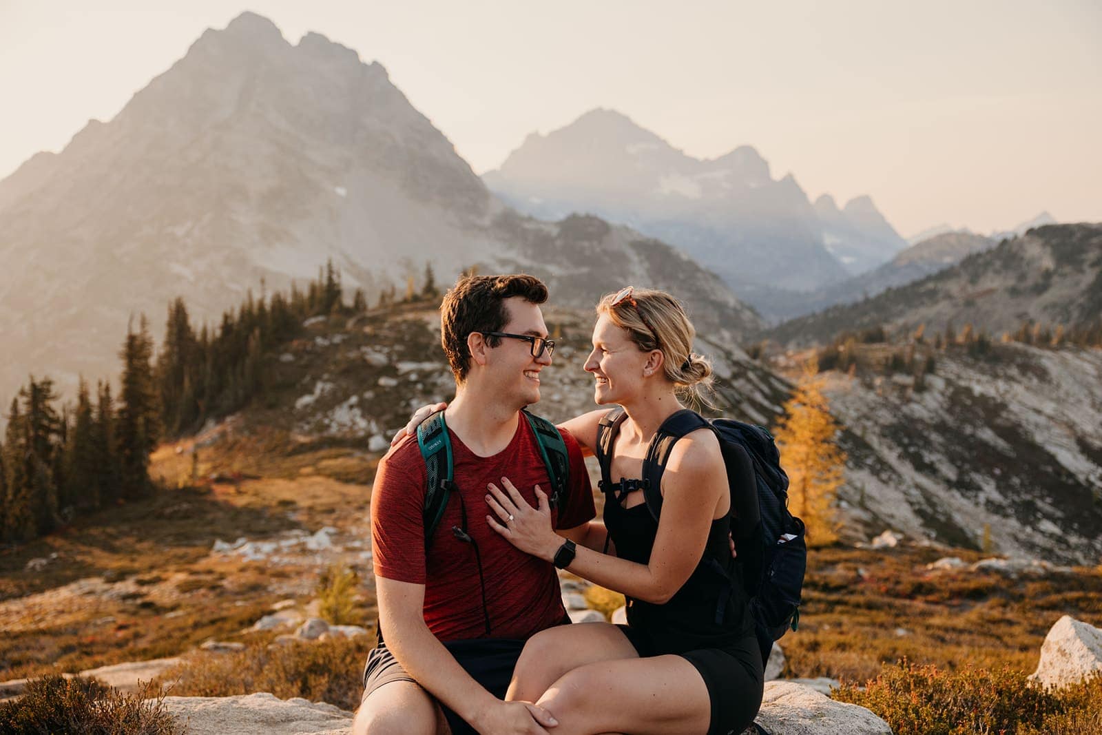 A couple smiles at each other having just got engaged on Maple Pass Loop.