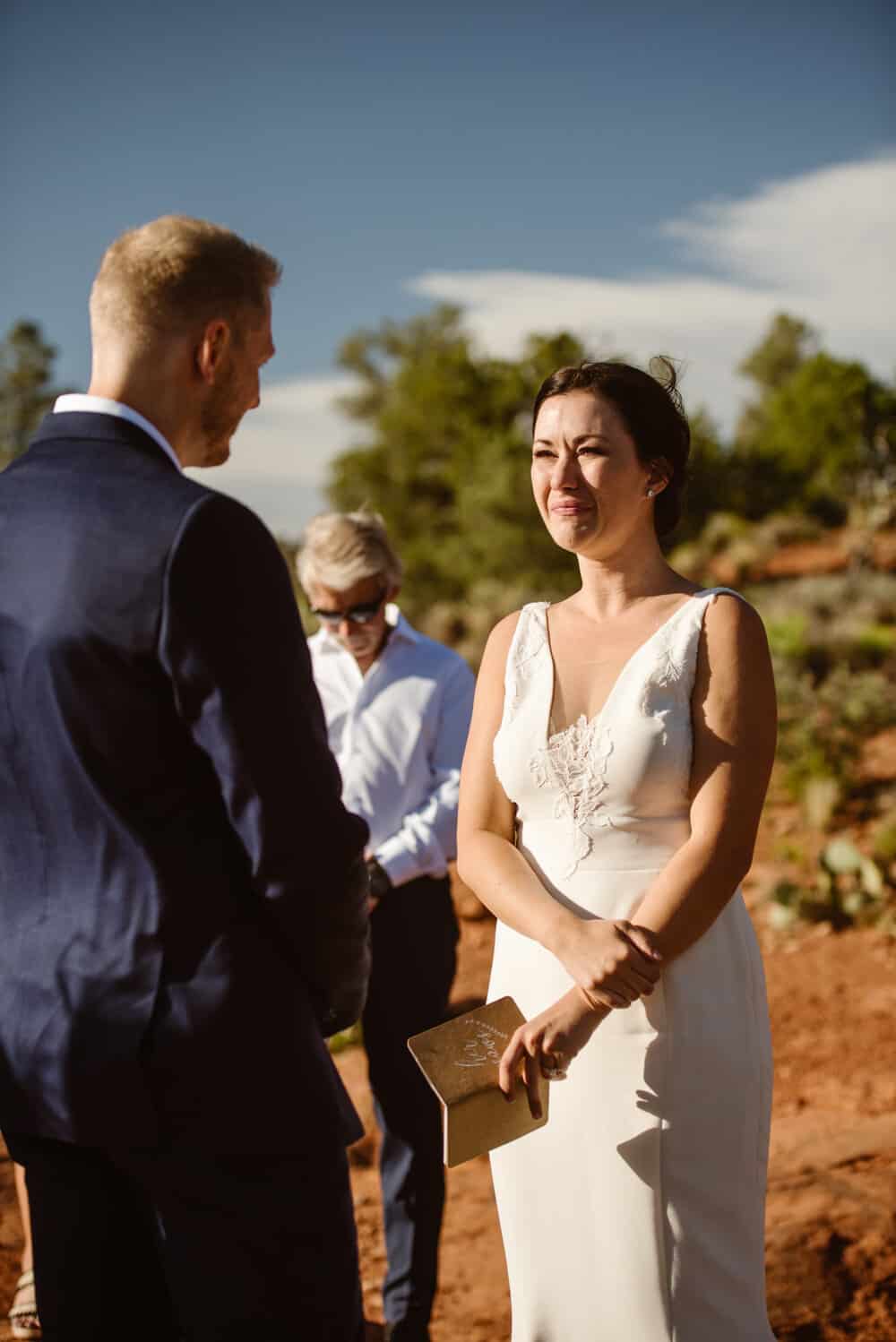 The bride is emotional as the groom shares his vows.