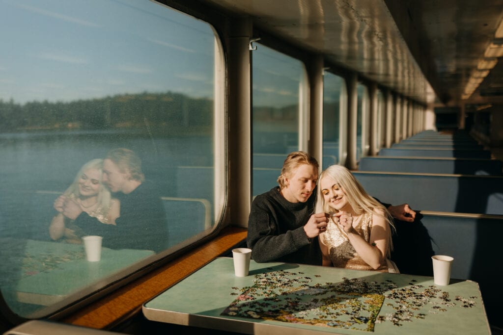 A couple puts together a puzzle while on the ferry.