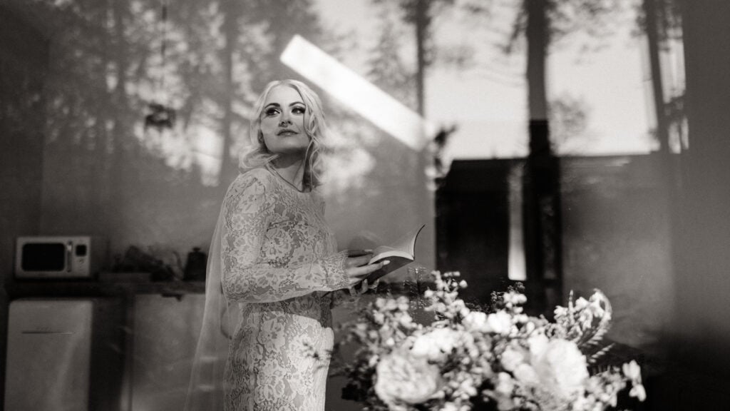 A bride looks out the window before seeing her groom.