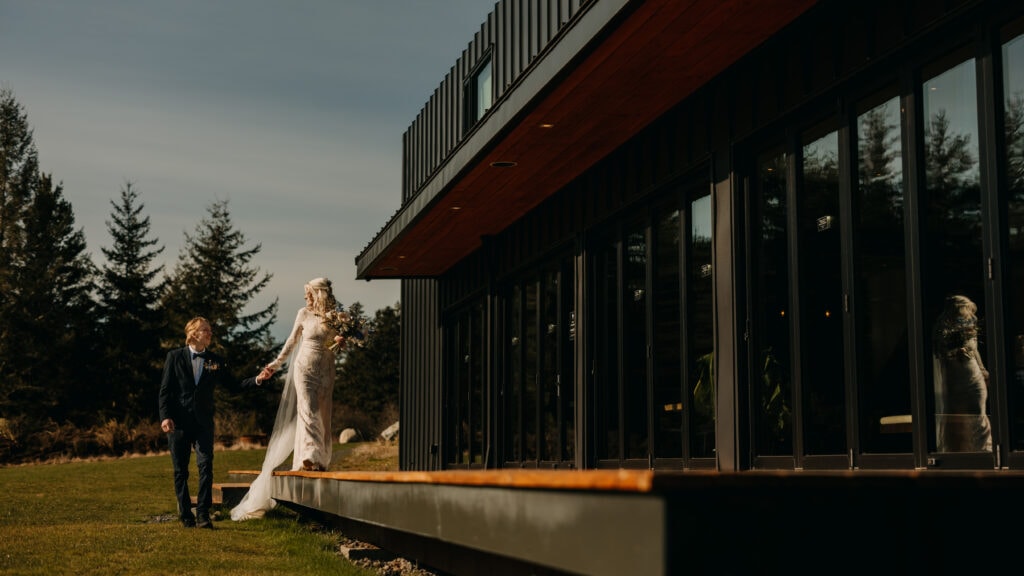 The bride and groom walk together around the venue.