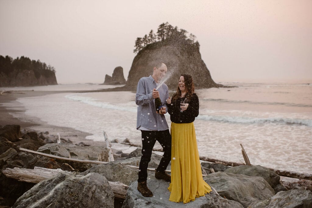 A couple celebrates their engagement at Rialto Beach